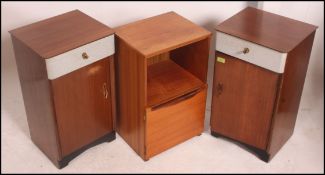 A pair of retro mid 20th century bedside tables / cabinets having a fabric covered drawers above