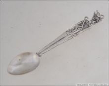 An Egyptian silver hallmarked tea spoon with figural stem marked with date letter in Egyptian