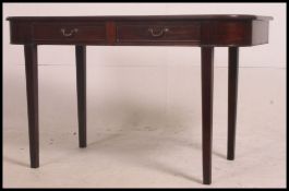 A 19th century D-End Georgian mahogany console / hall writing table being raised on tapered legs