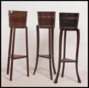 A collection of 3 1930's Lister of Dursley coopered oak barrels planter on raised legs with