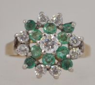 A 9ct gold and coloured green emerald garnet stone cluster ring.