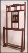 A Victorian mahogany arts and crafts hall stand having central glove box,