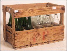 A vintage wooden crate with inset bottles dating to the 20th century.