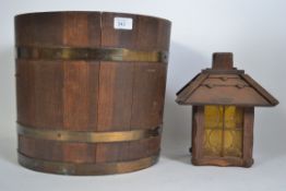 A coopered oak barrel planter having brass bindings together with a wooden arts and crafts lantern.