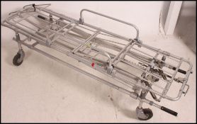 A retro 20th century hospital gurney - trolley bed of stainless steel construction with metamorphic