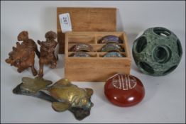 Wooden divided box containing five cloisonne napkin rings, two intricately carved dogs of Foo ,