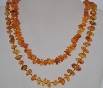2 good vintage mid century amber string necklaces, the amber of baroque style, one with screw clasp.