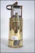 A vintage brass safety brass and copper submarine safety lamps, inscribed McGeoch,