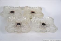 A set of four early to mid 20th century moulded frosted glass ceiling light fixtures.