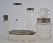 A collection of silver hallmarked cut glass dressing table items to include perfume vials,