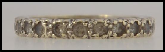 A 9ct gold eternity ring ( Size L ) seing set with 21 polished paste stone. 2.