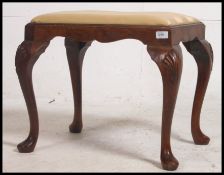 A Georgian revival pad feet dressing table stool with overstuffed velour upholstered seat raised on