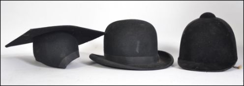 A vintage gentlemans bowler hat together with a school masters flat cap and a horse riding helmet.