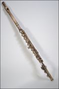 A 20th century Chinese made chrome flute with mother of pearl buttons makers name engraved on the