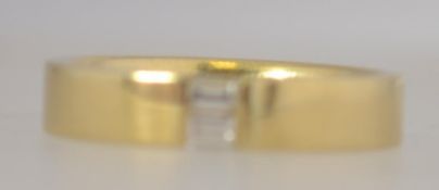 An 18ct gold and diamond ladies band ring, the diamonds being baguette cut approx 15-20pnts.