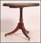 A good quality Regency style mahogany side / lamp / wine table raised on tripod base with tooled