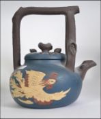 A Large Chinese Terracotta Kettle, a blue ground with a dragon raised to one side,