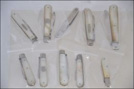A collection of 10 silver hallmarked fruit knives - pen knives.