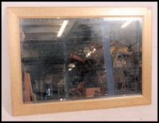 A large contemporary bevel edged wall hanging mirror having a gold speckled affect frame with a