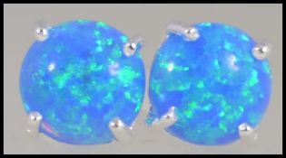 A pair of silver and blue opal stud earings