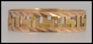 An 18ct gold Greek key design band ring, size O weighing .