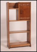 A 1930's oak open window bookcase cabinet having sectional bookcase shelves etc with fall front