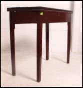 A Georgian solid mahogany tea table raised on squared legs with fold over table top supported on