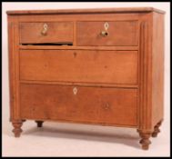A Victorian pine 2 over 2 cottage chest of drawers raised on bun feet with knob handles to the