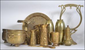 A large collection of brass wares to include stands, tall trivets, ornaments, vases,