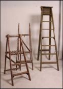 A collection of 3 retro ladders to include 1 large wooden example and 2 painted smaller versions.