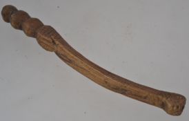 A 19th century treen knitting sheath being shaped and detailed with chase decoration