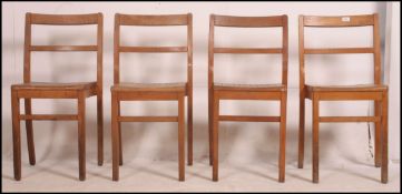 A set of 4 vintage slatted beechwood school - stacking hall chairs raised on squared legs united by