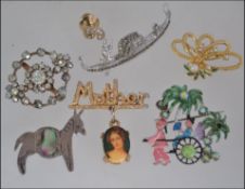 A collection of 7 vintage brooch pins to include white metal long ship brooch,