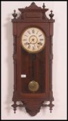 A 19th century Ansonia vienna regulator wall clock in mahogany case with glass window housing