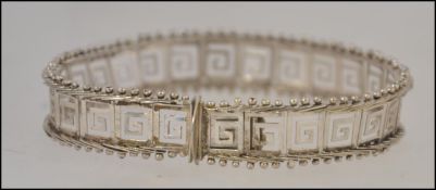 A 925 silver bracelet of Greek key design stamped to the clasp 925 and having a length of 18.
