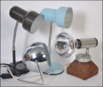 A collection of four retro 20th century desk lights to include a pair of different coloured