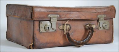 A Victorian leather vanity case of good quality having an appointed interior with hinged centre