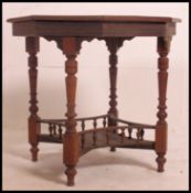 A late Victorian mahogany octagonal occasional centre table being raised over four baluster ring