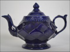 An early 19th Century blue glazed teapot of interesting form .