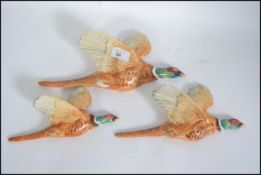 A set of three vintage graduating wall hanging Pheasants,