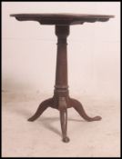 A 19th century tilt top country oak occasional table in oak having a circular top having turned
