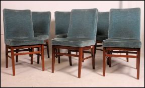 A set of 6 mid century teak dining chairs by Alfred Cox together with a matching circular extending