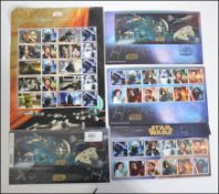 A small collection of Royal Mail Mint Stamps presentation packs all relating to Star Wars,