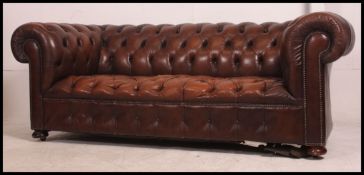 A good 20th century antique style brown leather Chesterfield sofa settee being button backed and
