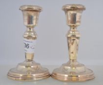 A pair of matching filled silver hallmarked stump candle sticks with Birmingham assay marks 245.