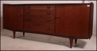 A 1970's Youngers Teak wood sideboard of low wide,