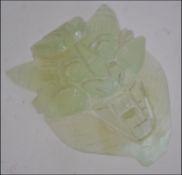 A Chinese celadon jade belt buckle carved into the form of a dragon L6cm