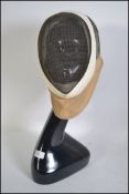 A vintage fencing mask by Leon Play together with an art deco style mannequin shop display dummy