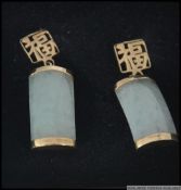 A pair of jade and 9ct gold drop earrings the earrings of oblong form with sleeper clasp fittings