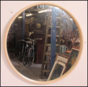 A 1950's large atomic style retro circular wall mirror set within original white resin surround.